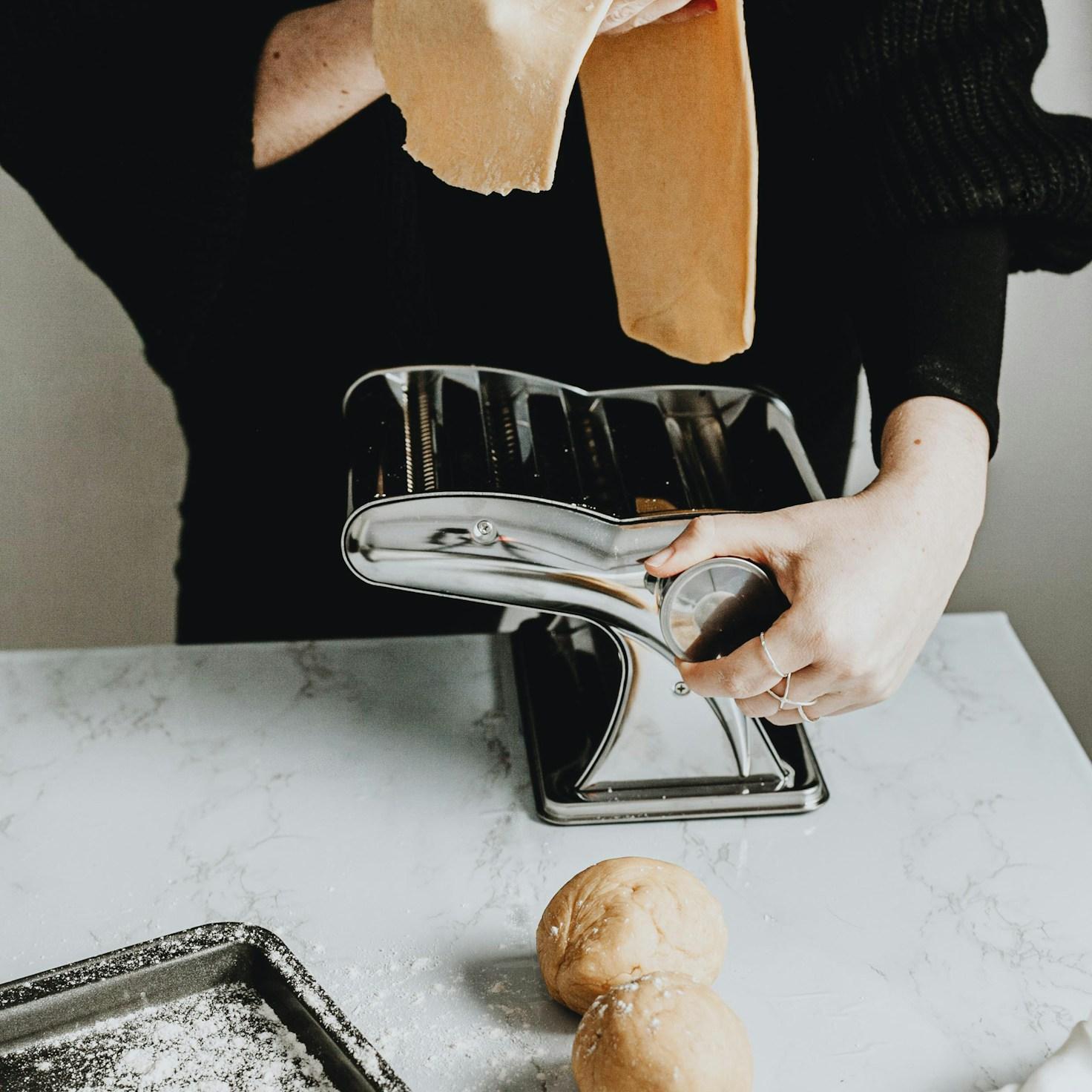 Diverse group of community members sharing a meal together, showcasing the social bonds formed through collaborative cooking